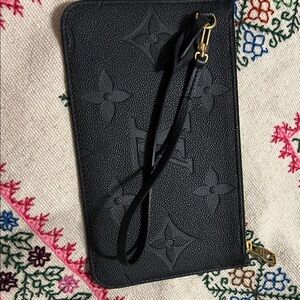 Louis Vuitton wristlet black.

Black Embossed Wristlet with Gold Accents